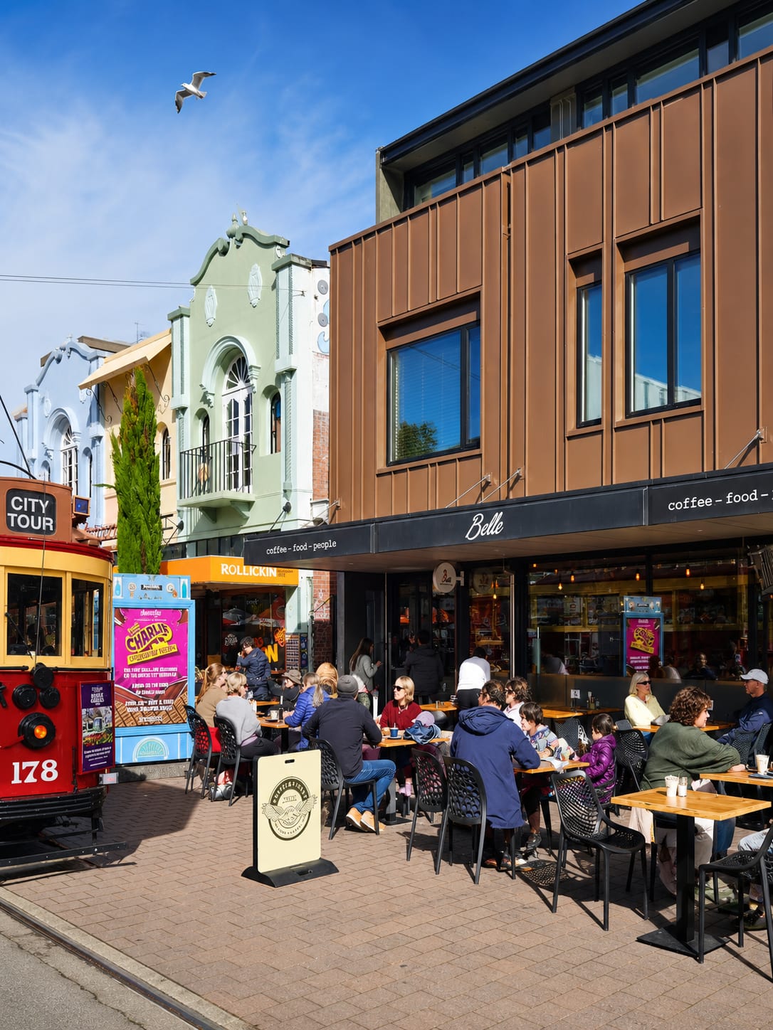 Belle's Armagh Street frontage with outdoor tables and city tram
