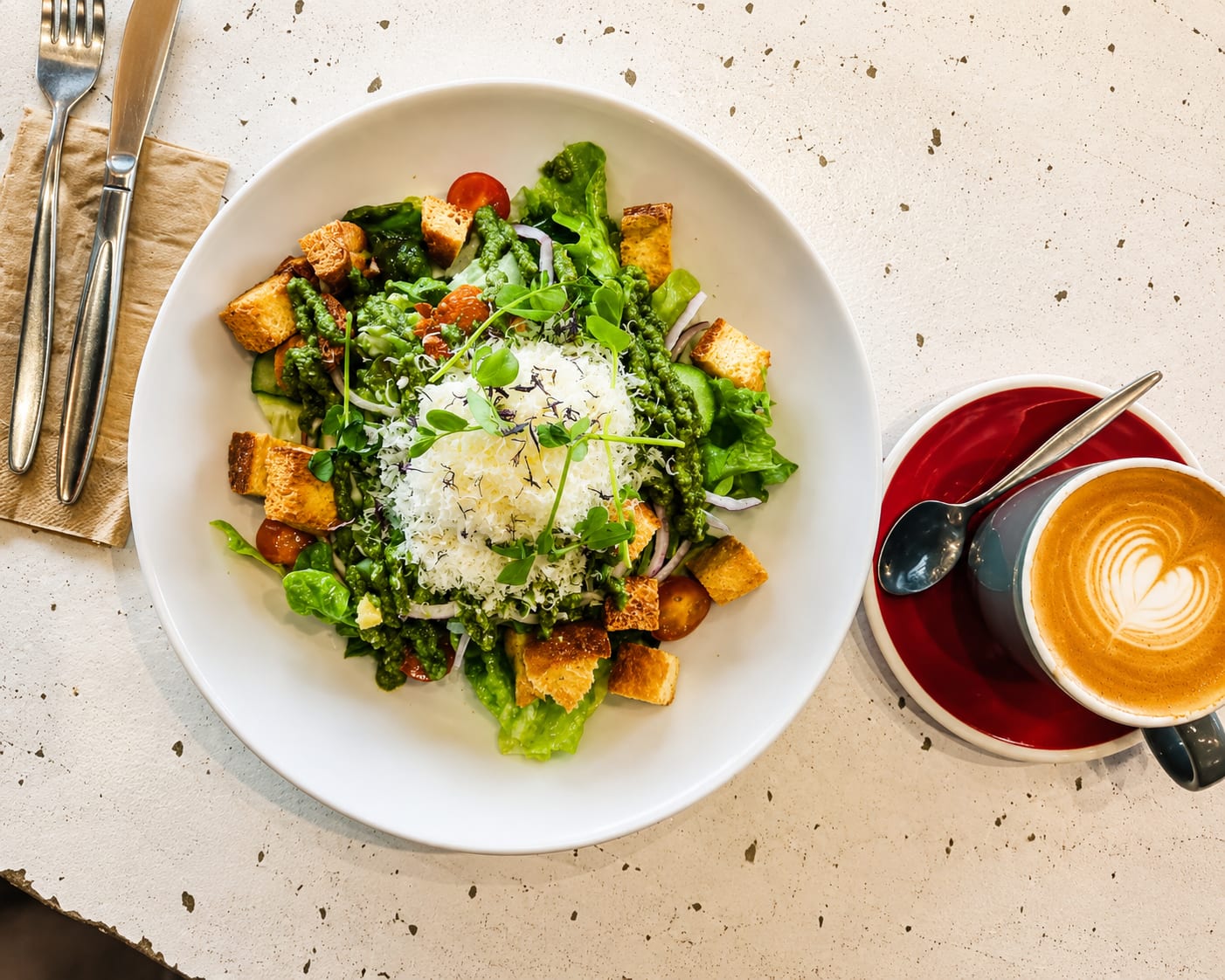 A green salad and latte coffee served at Belle